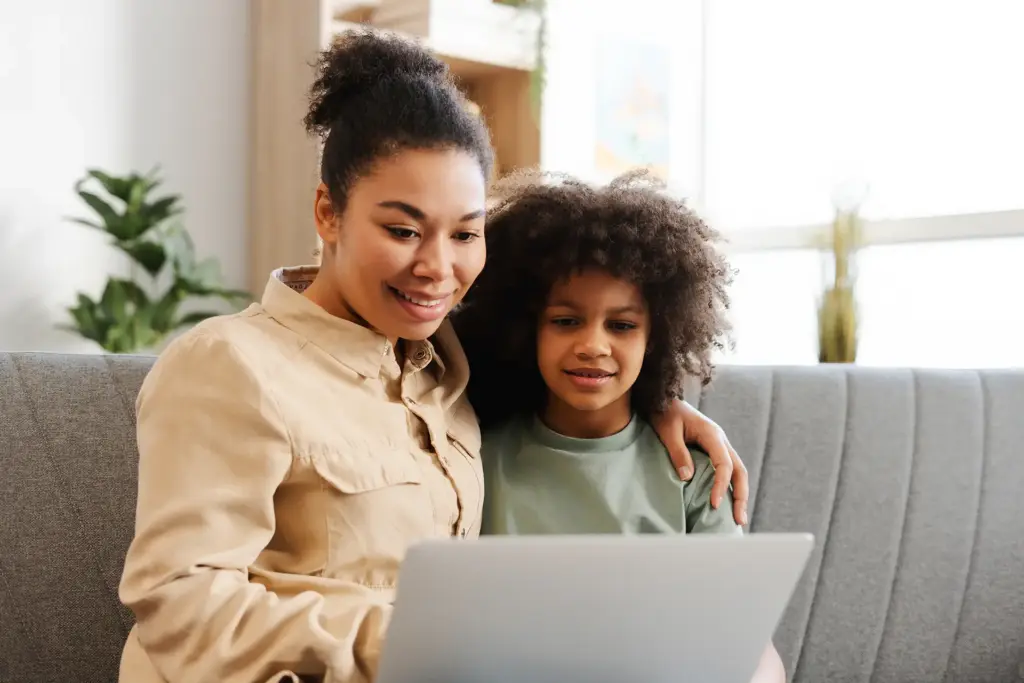 smiling-mother-and-her-little-daughter-using-lapto-2025-02-20-11-12-34-utc